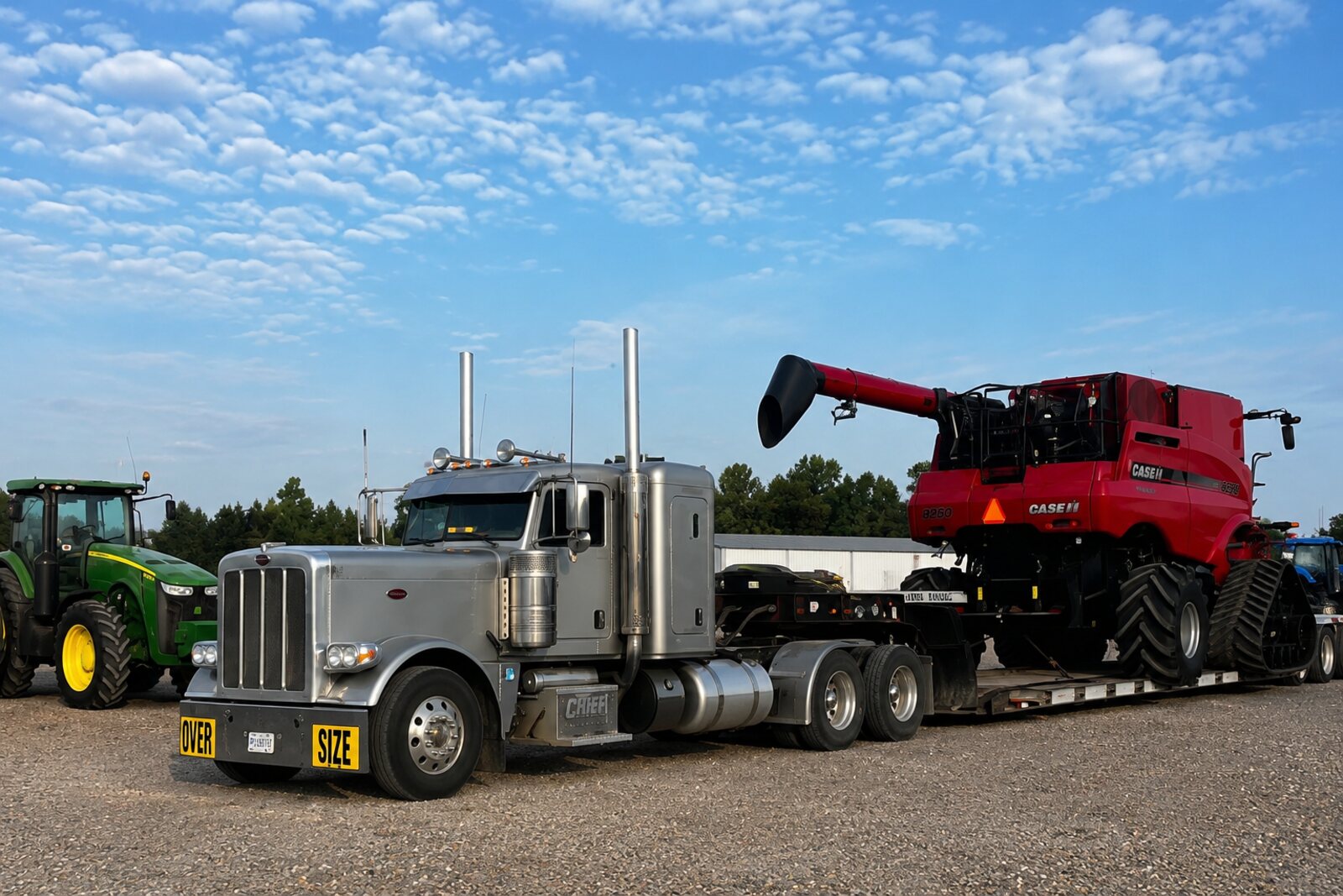 AG Motion Peterbilt hauling a Case IH combine on a lowboy trailer