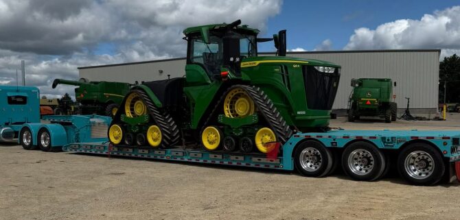 AG Motion hauling a John Deere 9RX tractor