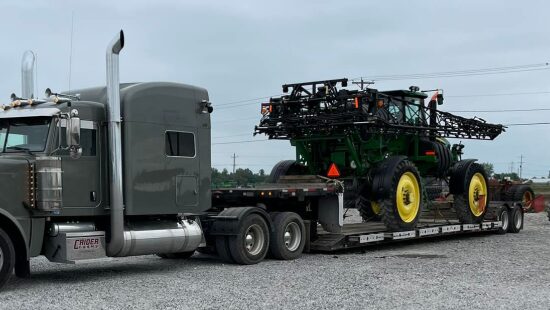 AG Motion hauling a John Deere spray rig